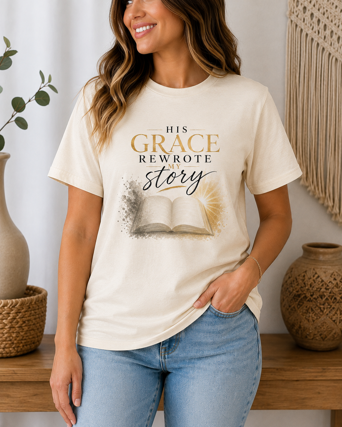 His Grace Rewrote My Story Christian apparel t-shirt in soft natural with gold script and watercolor open Bible.