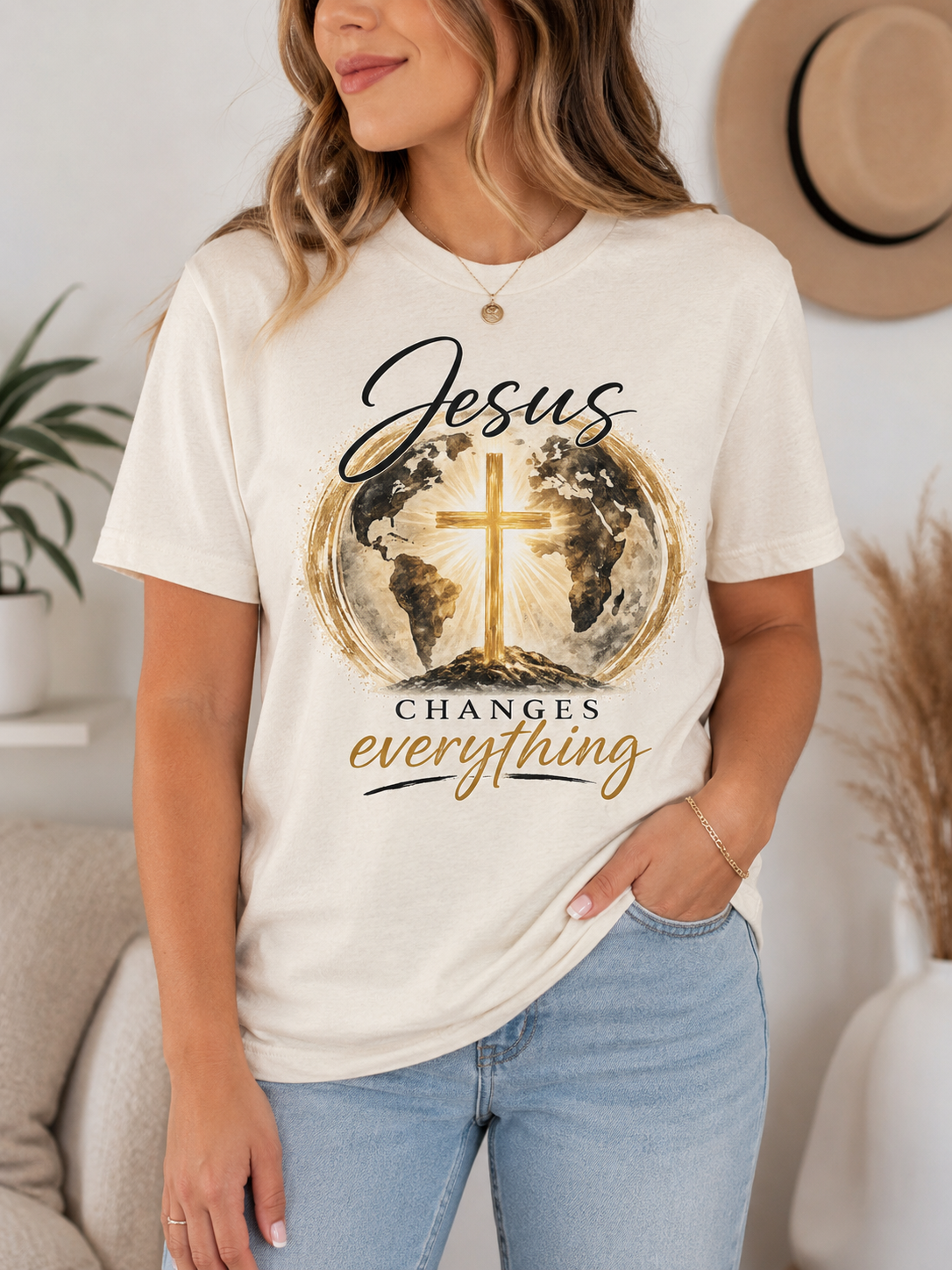 Jesus Changes Everything Christian t-shirt in soft natural with gold cross and world watercolor front design.