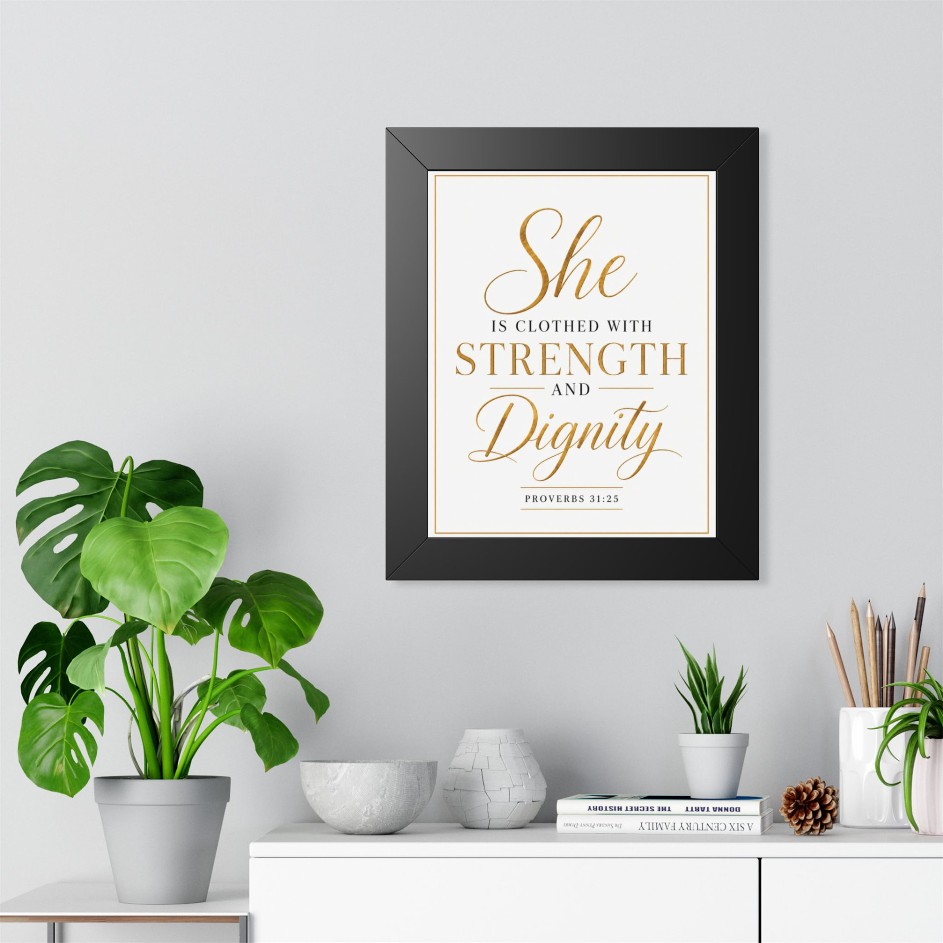 She is clothed with strength and dignity Proverbs 31:25 framed Christian wall art in a black 11x14 frame.